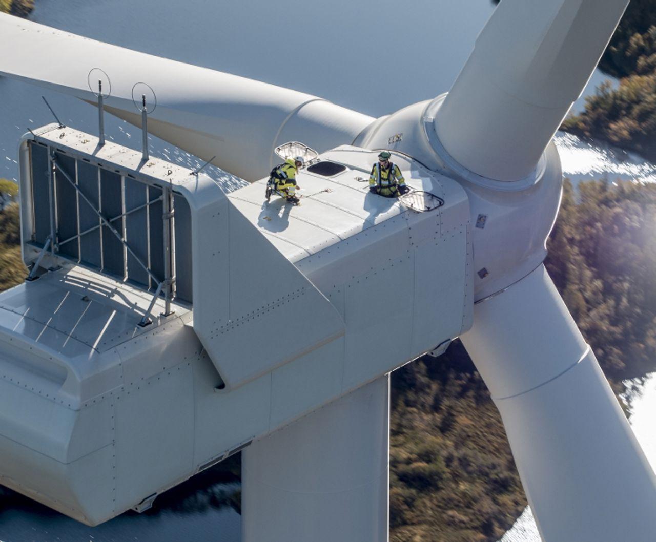 People working on top of wind turbine